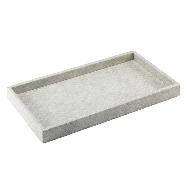 The Tresse Vanity Tray - Artic by Bodrum features a rectangular shape in light gray with a subtle diamond-patterned texture, raised edges, and a simple, modern design—perfect for luxury home decor.