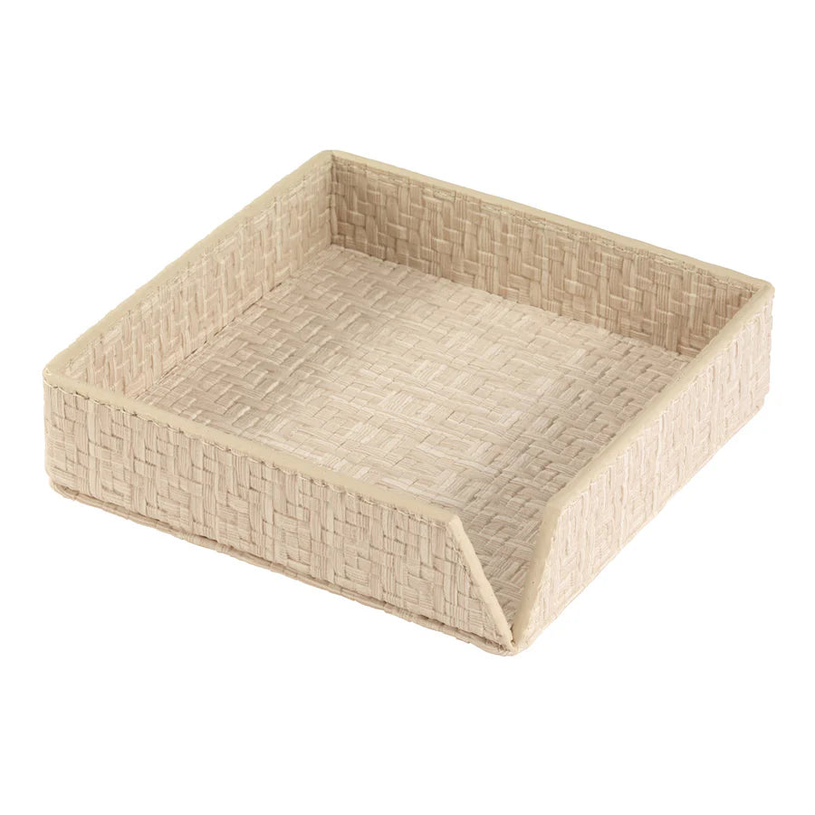 The Bodrum Wicker Cocktail Napkin Holder is a square, beige basket with low sides and an open angled front, perfect for organizing napkins or small essentials.