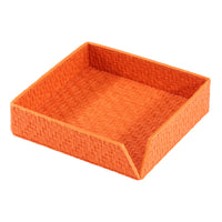 The Bodrum Wicker Cocktail Napkin Holder is a square orange basket tray with an open front edge, made from phthalate-free vinyl resembling woven straw, ideal for holding napkins or small items.