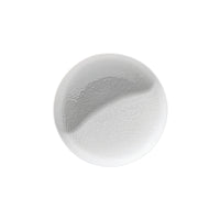 A clear, round droplet of liquid with a smooth texture and subtle wave pattern rests on Raynaud Mineral Dinnerware Glazed White by Raynaud, set against a pristine white background.