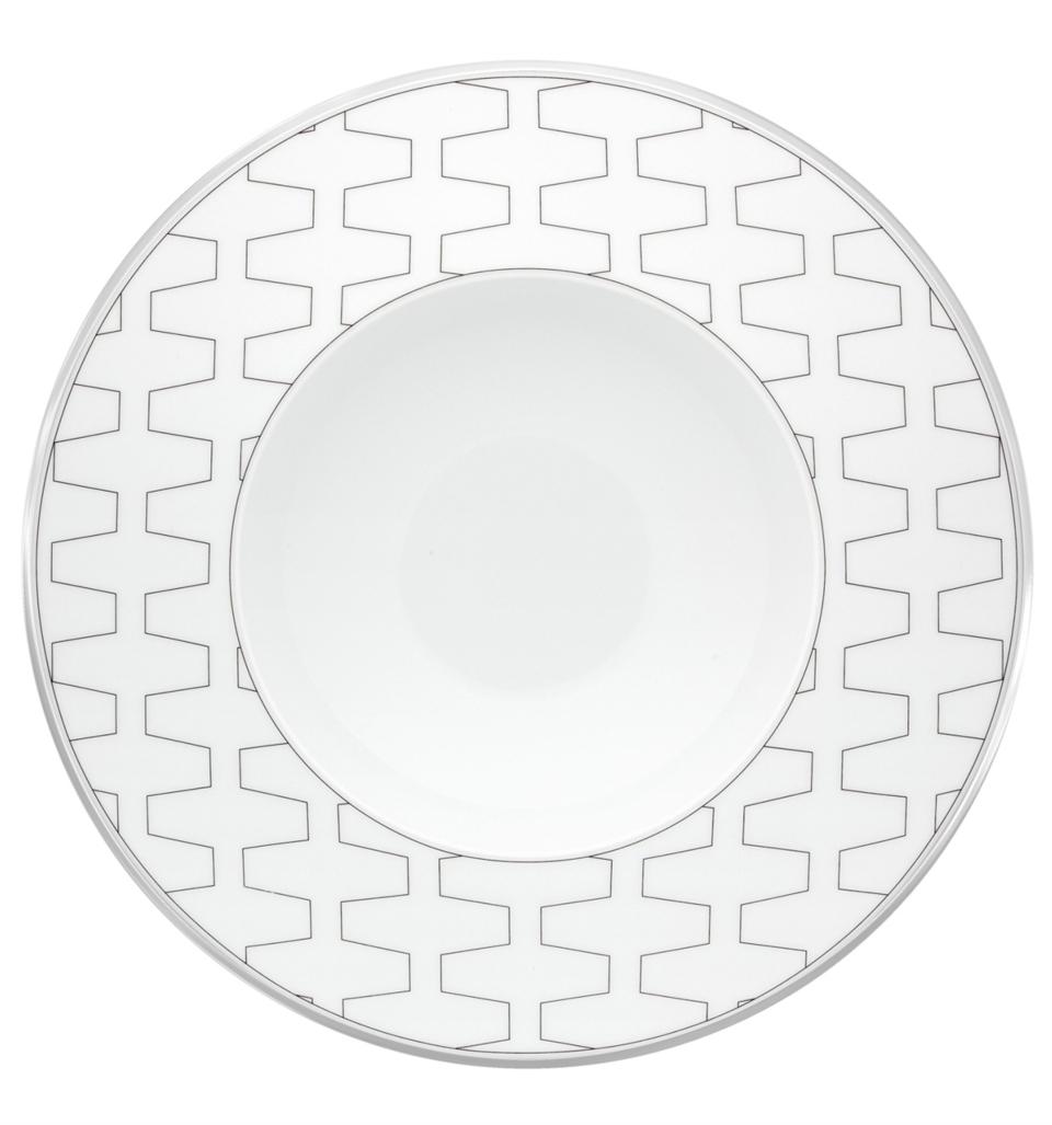 The Vista Alegre Trasso Dinnerware plate features a wide rim with a repeating geometric pattern of interconnected gray zigzags, while its plain center highlights the elegant design typical of Trasso porcelain.