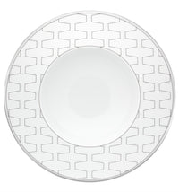 The Vista Alegre Trasso Dinnerware plate features a wide rim with a repeating geometric pattern of interconnected gray zigzags, while its plain center highlights the elegant design typical of Trasso porcelain.