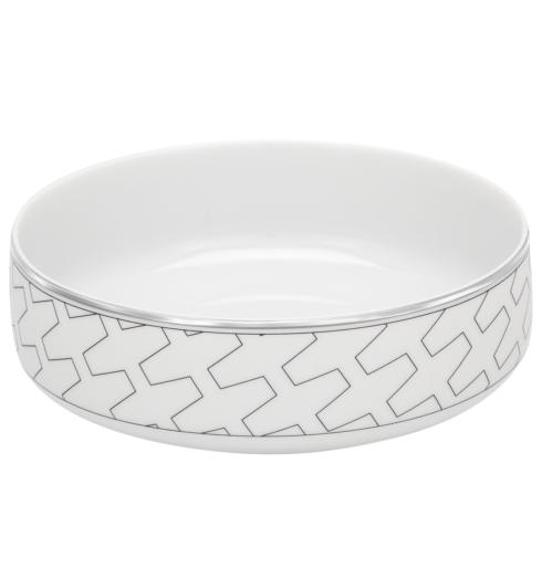 The Vista Alegre Trasso Dinnerware is a round, white ceramic bowl with a gray geometric interlocking pattern around the outer side and a slim silver rim on top. The interior remains plain white.