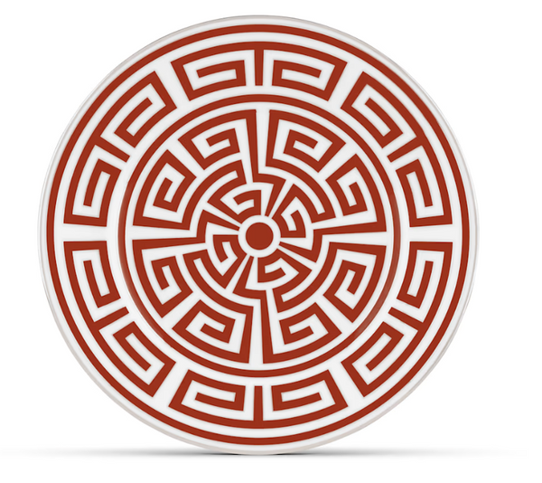 The Ginori 1735 Labirinto Dinnerware Scarlatto is a round porcelain plate made in Italy, featuring bold red and white concentric circles and angular maze-like lines—an iconic geometric design.