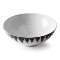 The Molecot Punk Dinnerware is a white ceramic bowl featuring a black zigzag rim pattern, showcasing modern style against a white background.