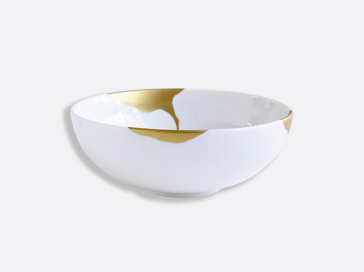 The Bernardaud Kintsugi Dinnerware bowl, crafted from white Limoges porcelain with gold-repaired cracks in the Japanese kintsugi style, is displayed against a plain light gray background.