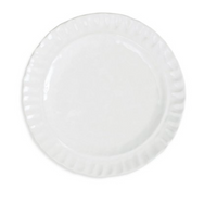 The Vietri Pietra Serena ceramic plate features a plain white design with a slightly scalloped, textured rim—an elegant piece shown from above on a white background, perfect for any white dinnerware set.