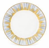 Marie Daâge Panache white Limoges porcelain dinner plate with a gold-rimmed edge and a border of vertical, brushed blue and gold stripes.