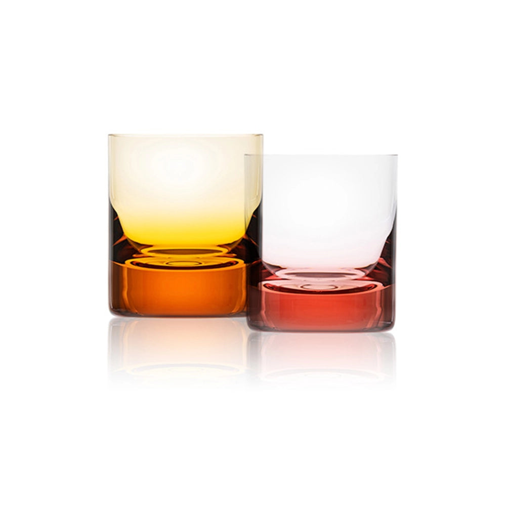 Two Moser Whiskey Set DOF Glasses (370 ml) sit side by side on a white background: one amber yellow and the other reddish amber, both crafted from lead-free crystal with thick colored bases and clear upper sections.