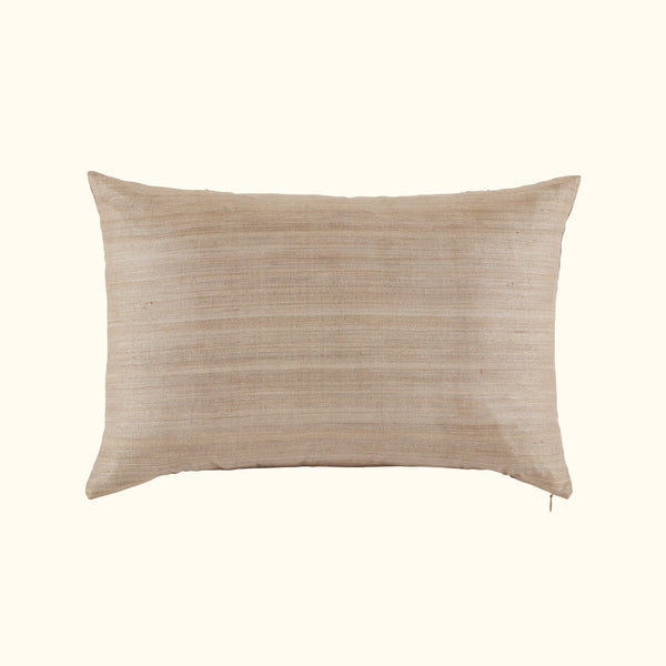 The Kasai Pillow 16 x 24 by Threads Soft Goods is a rectangular beige throw pillow with subtle horizontal stripes, inspired by Kuba cloth designs, shown against a plain off-white background.