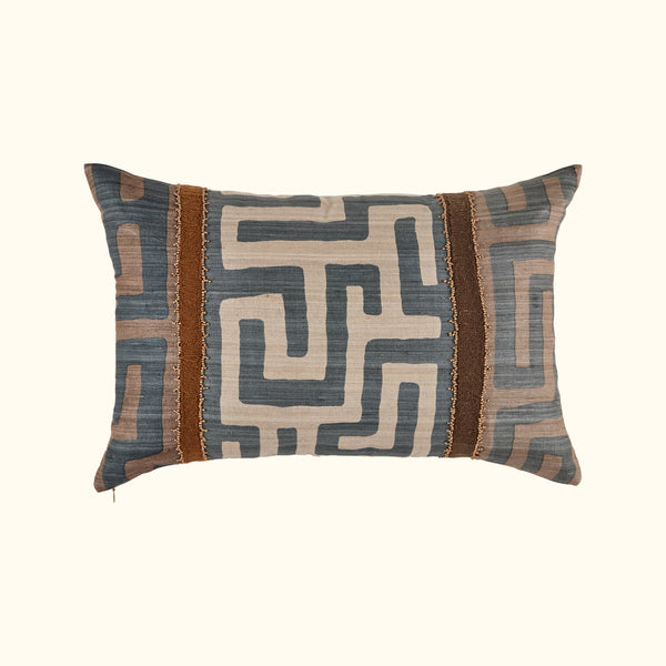 The Kasai Pillow 16 x 24 from Threads Soft Goods features a geometric maze-inspired design in blue, beige, and brown with two vertical brown textured stripes and decorative trim, handcrafted and inspired by Kuba cloth pillows.