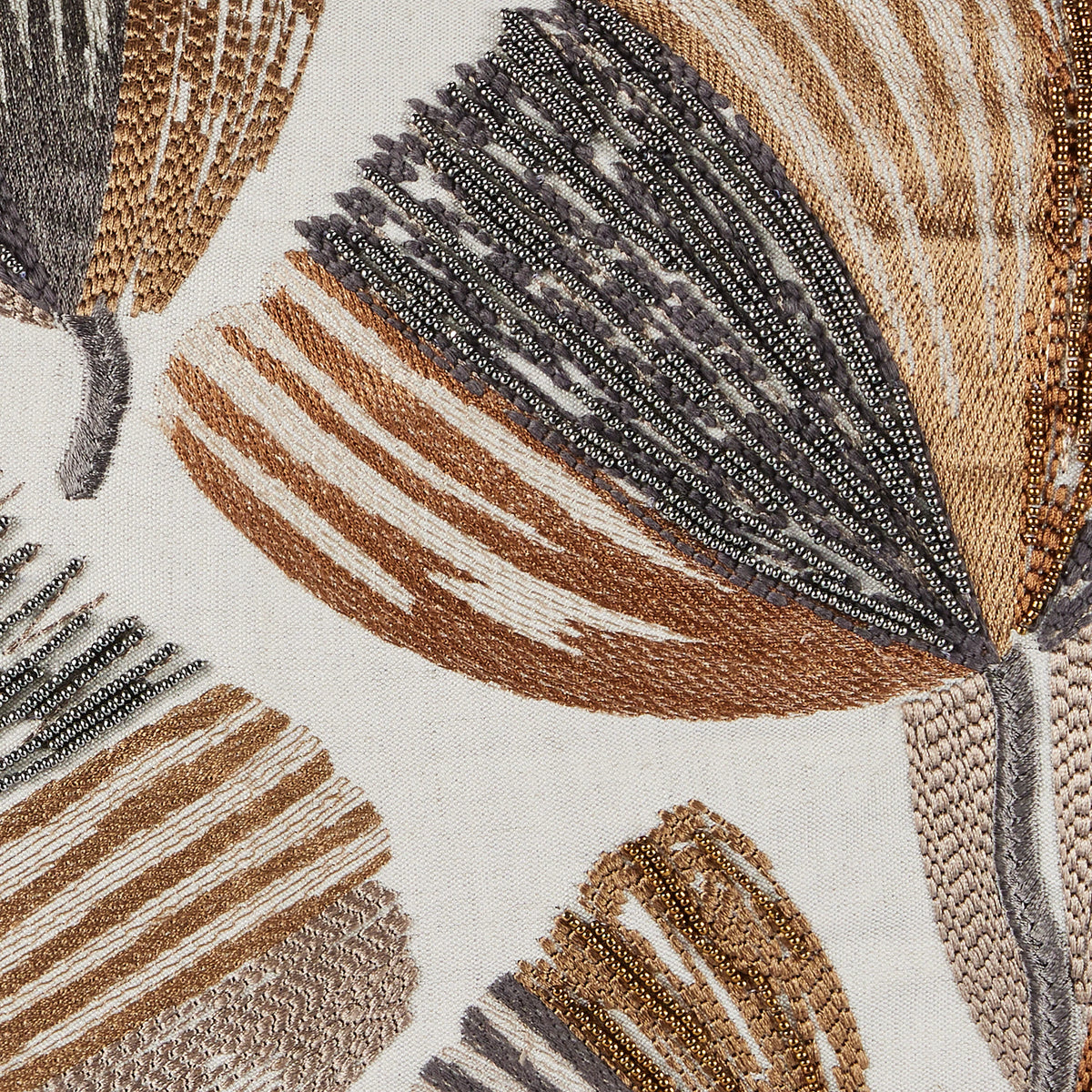 The Moonflower Pillow 16 x 24 by Threads Soft Goods features large abstract leaf patterns in brown, beige, and gray with intricate beadwork and textured stitching on light fabric.