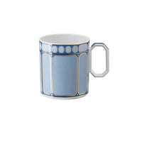 The Swarovski Signum Azure Blue Mug by Swarovski x Rosenthal features gold trim, a geometric pattern of rectangles and circles, and a white faceted handle inspired by Swarovski crystals.