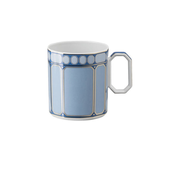 The Swarovski Signum Azure Blue Mug by Swarovski x Rosenthal features gold trim, a geometric pattern of rectangles and circles, and a white faceted handle inspired by Swarovski crystals.