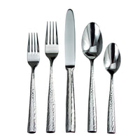 The Ricci Anvil Flatware 5 Piece Setting includes two forks, a knife, a large spoon, and a small spoon with hammered texture, all made of 18/10 stainless steel and displayed on a white background.