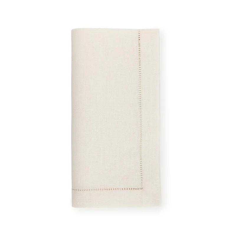 The Sferra Festival Napkin Set of 4 features neatly folded, off-white European linen napkins with simple hemstitch borders, displayed against a plain white background.