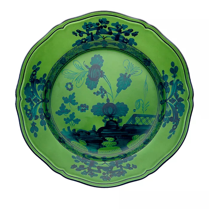 A green ceramic plate from the Ginori 1735 Oriente Italiano Dinnerware Malachite collection, featuring scalloped edges and intricate dark blue floral and leaf patterns with an ornate border design, showcases the refined artistry and elegance characteristic of Italian tableware. This piece brings a sophisticated touch to any dining setting.