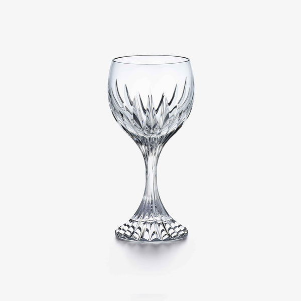 A clear crystal Massena Glass Large by Baccarat, featuring an ornate faceted design on both the bowl and stem, stands against a plain white background—an exquisite example of luxury barware at its finest.