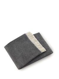 The Grain of Rice Throw by A Soft Idea is a dark gray, textured fabric with a cream stripe along one edge, reminiscent of a super soft napkin, shown on a white background.