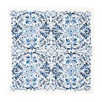 The Juliska Iberian Napkin Indigo - Set/4 features a symmetrical blue and white floral design inspired by the Iberian Journey, with intricate patterns reminiscent of cobalt blue tiles on a crisp white background.