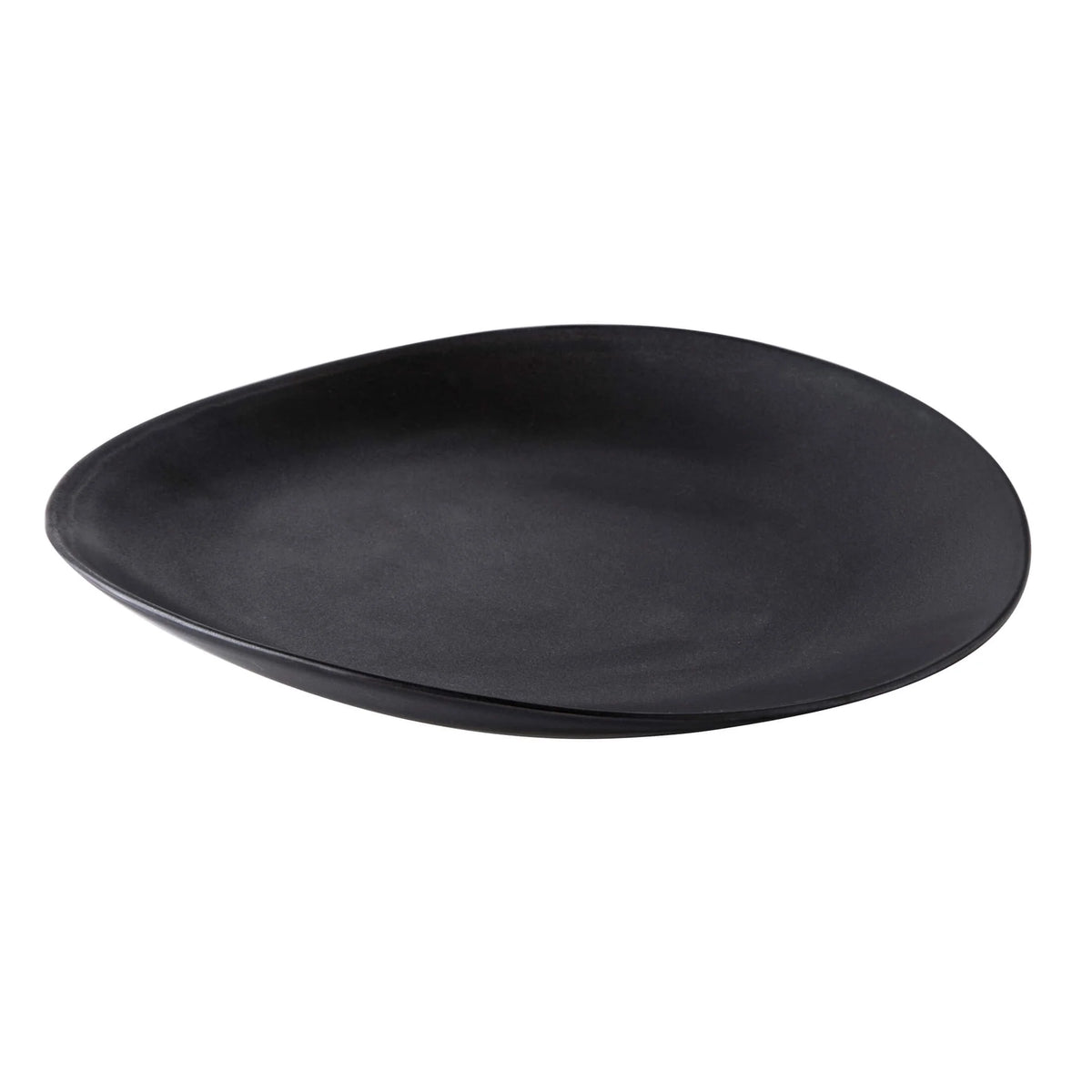 The Simon Pearce Barre Dinnerware Slate is a black, asymmetrical stoneware plate with a smooth matte finish, shown on a white background as part of their modern dinnerware set.