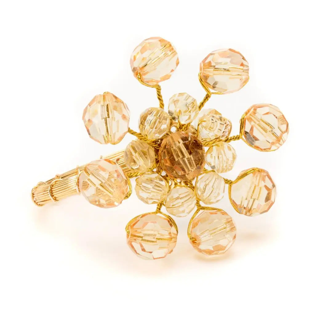 The Party Burst Beaded Napkin Ring Set of 4 by Deborah Rhodes features faceted, translucent beads arranged like petals on gold wire stems, exemplifying artisanal craftsmanship—all showcased against a white background.