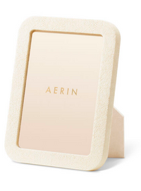 The Aerin Modern Shagreen Frame Cream features an embossed shagreen texture and a sleek cream finish, ideal for minimalist, contemporary décor.