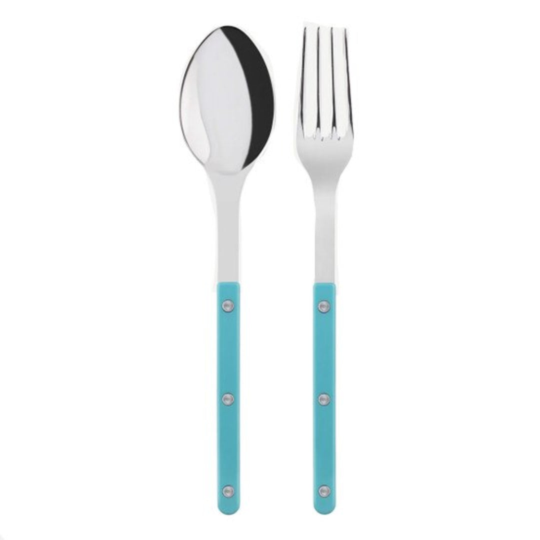 The Sabre Bistrot Shiny Solid Serving Set features a metal spoon and fork with blue handles and three silver rivets, side by side on a white background—ideal for adding Parisian flair to your table.