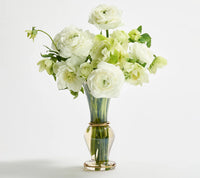 The Kim Seybert Champagne Rib Gold Detail Vase, made from clear mouth-blown glass, is shown filled with white and pale green roses and ranunculus against a plain white background.