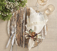 Create a rustic dining decor with the Kim Seybert Weathered Pine Placemat Ivory and Natural Set of 4, fringed beige napkins, silver cutlery, glassware, and a green-and-white berry arrangement for a festive table setting.