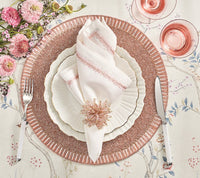 Elegant table setting featuring Kim Seybert’s Jardin Napkin Set of 4, layered pink and white plates, sparkling napkin ring, silver cutlery, pink wine glasses, and pink florals on a floral-patterned tablecloth.