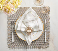 Elegant table setting featuring a white plate with gold rim, white stitched napkin with Kim Seybert Flare Napkin Ring Gold, silverware, wine glass, yellow flowers in the corner, all atop a textured placemat.