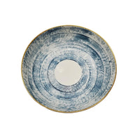 A round ceramic bowl from the Marie Daage Agate Dinnerware collection by Marie Daâge, featuring a white center, blue textured circular pattern, and a thin gold rim—evocative of exquisite French porcelain tableware.