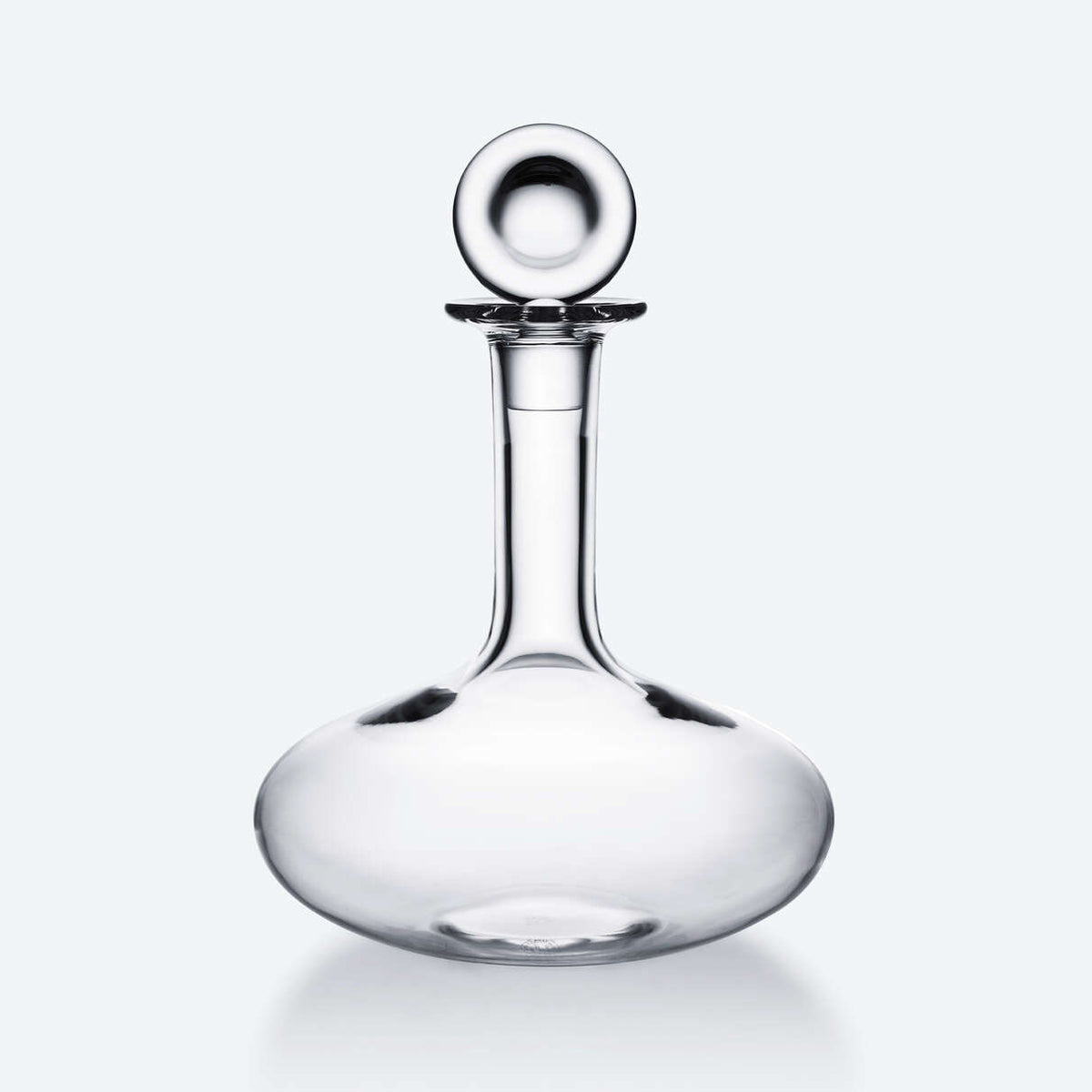 The Baccarat Oenologie Decanter by Baccarat features a clear crystal design with a wide, round base and tall, narrow neck topped by a spherical stopper—a sophisticated wine aerator for refined tasting experiences.