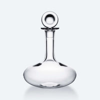 The Baccarat Oenologie Decanter by Baccarat features a clear crystal design with a wide, round base and tall, narrow neck topped by a spherical stopper—a sophisticated wine aerator for refined tasting experiences.