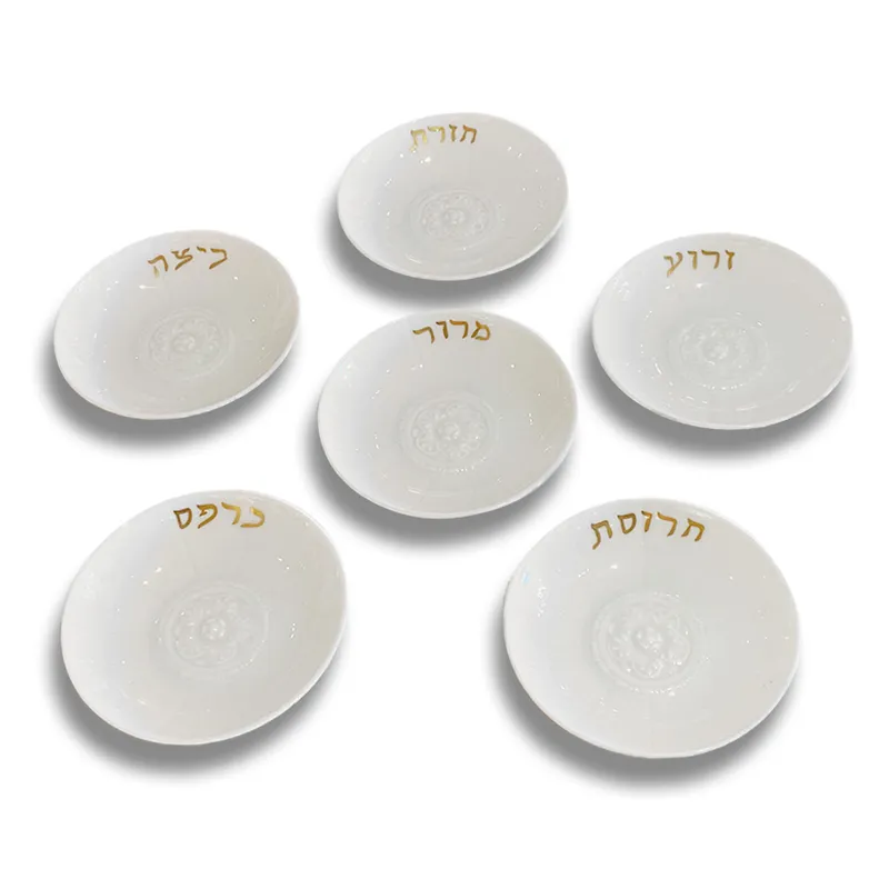 The Bernardaud Louvre Seder Dishes Set of 6, crafted from white ceramic with gold Hebrew lettering, makes a timeless heritage gift—ideal for displaying symbolic foods at Passover.