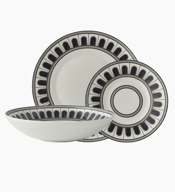 The Greg Natale Palazzo Navy Dinnerware 3 Piece Set includes a dinner plate, salad plate, and bowl, each with a white base and bold black, navy blue, and red geometric borders for a modern, symmetrical touch.