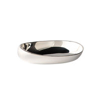 The Greg Natale Pietra Catchall is a shiny, oval dish featuring an organic design with smooth, curved edges, displayed against a plain white background.