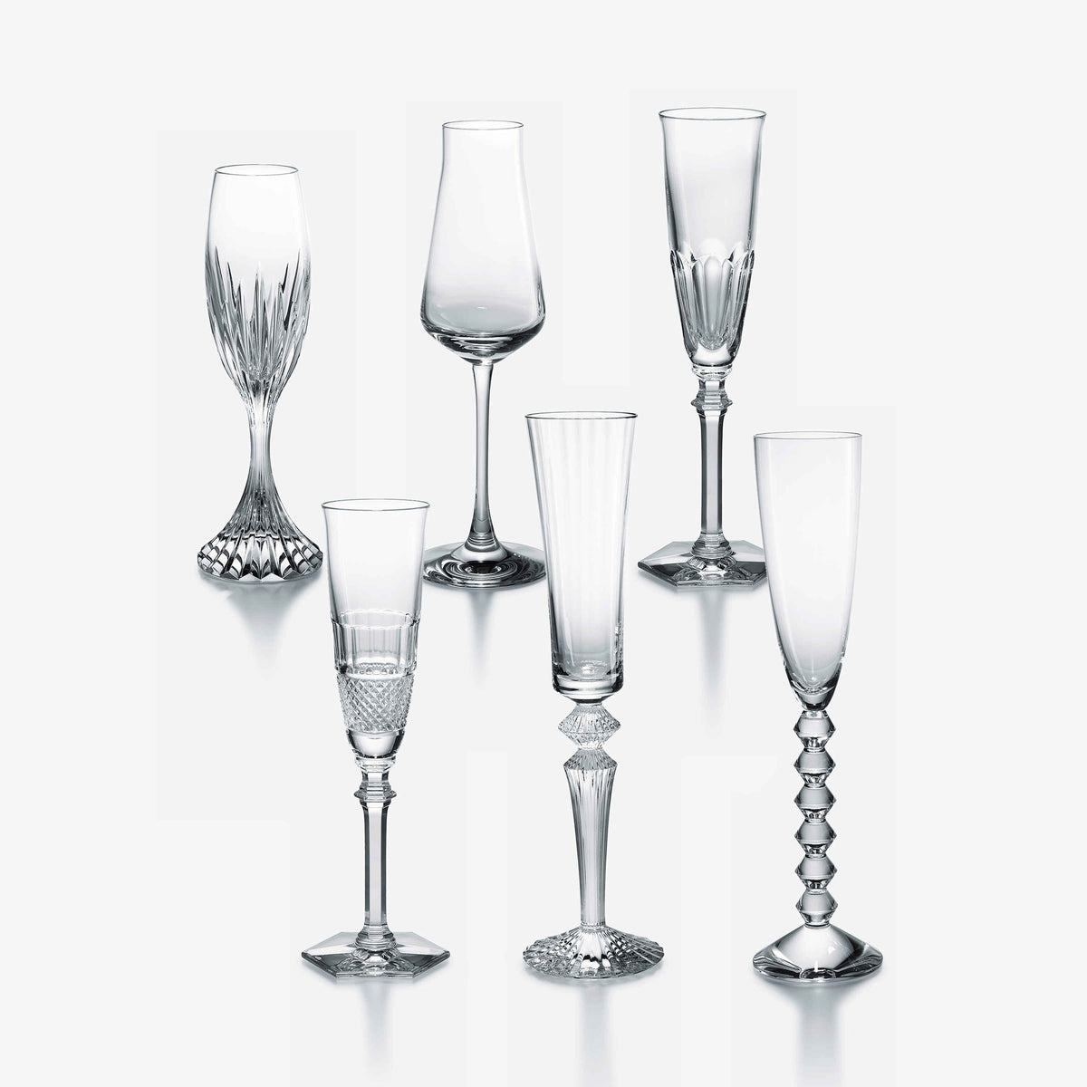 Six elegant, empty Baccarat Best Seller Bubble Box Flutes are arranged in two rows on a plain white background, showcasing their unique stem and bowl designs—a perfect gift set for any celebration.