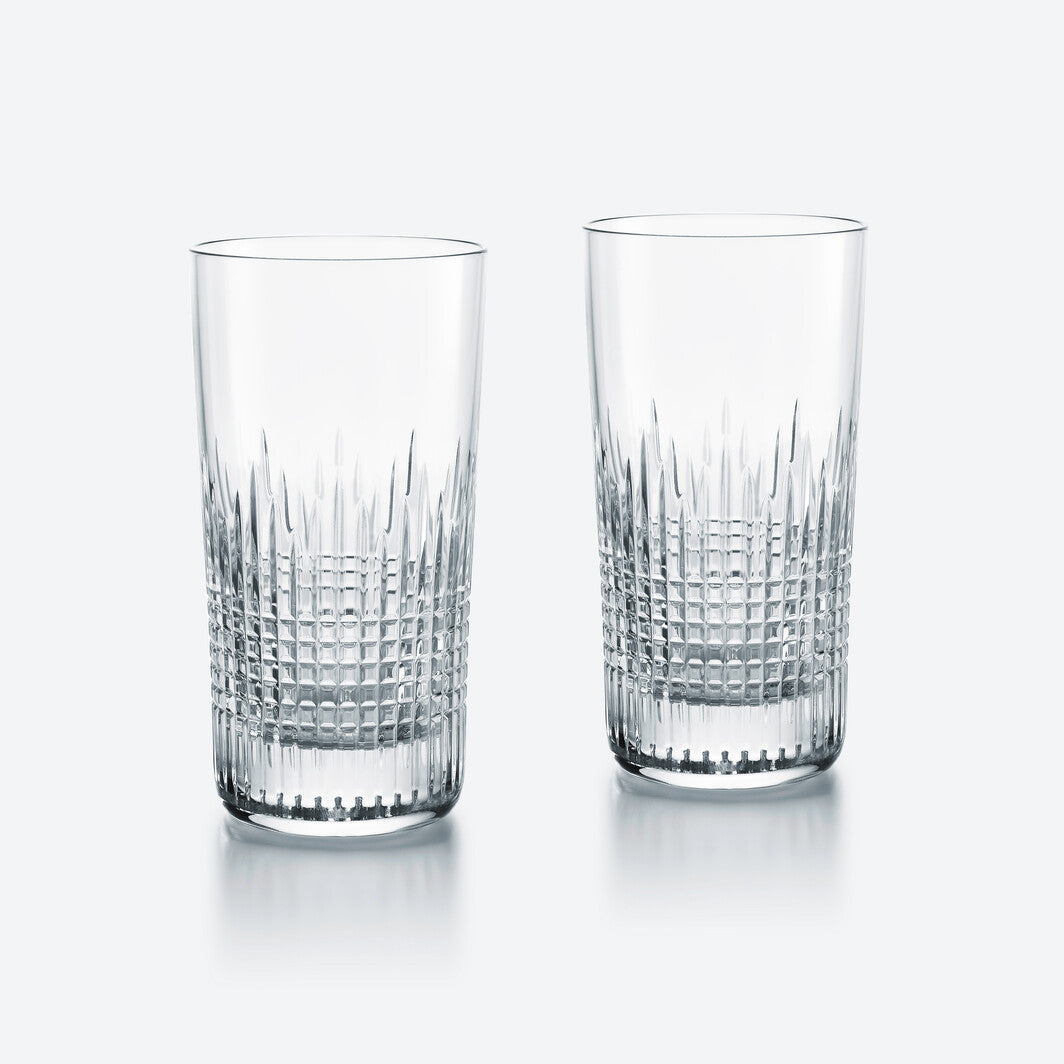 Two Baccarat Nancy Barware Set of 2 crystal tumblers, showcasing elegant geometric cuts, are displayed side by side on a simple light background.
