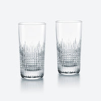 Two Baccarat Nancy Barware Set of 2 crystal tumblers, showcasing elegant geometric cuts, are displayed side by side on a simple light background.