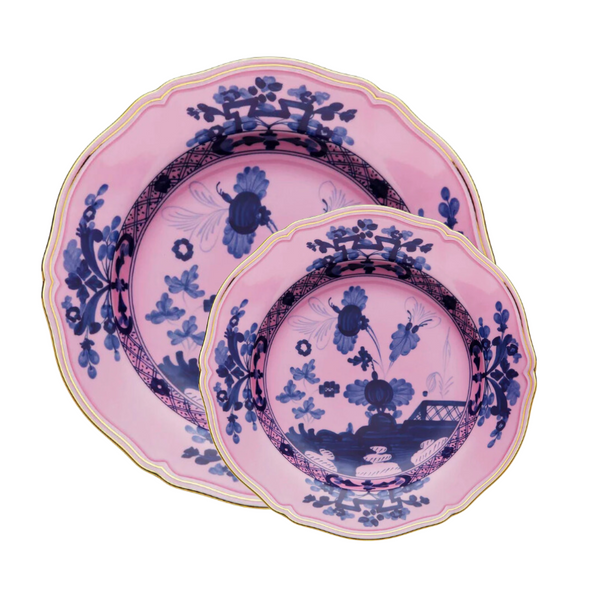 Two Oriente Italiano Azalea plates by Ginori 1735—stacked with the smaller on top—showcase a dark blue chinoiserie floral motif and gold-trimmed edges, bringing an elegant touch to your decor.