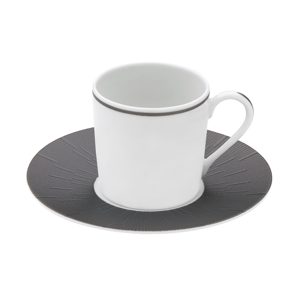 A Haviland Anthracite Infini Dinnerware Grey cup with a thin gray rim sits on a matching saucer featuring a dark gray, textured radiating pattern. Both are crafted from Limoges porcelain, set against a plain white background.
