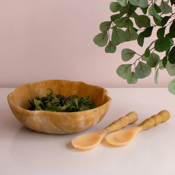 resin salad bowl and servers on a table