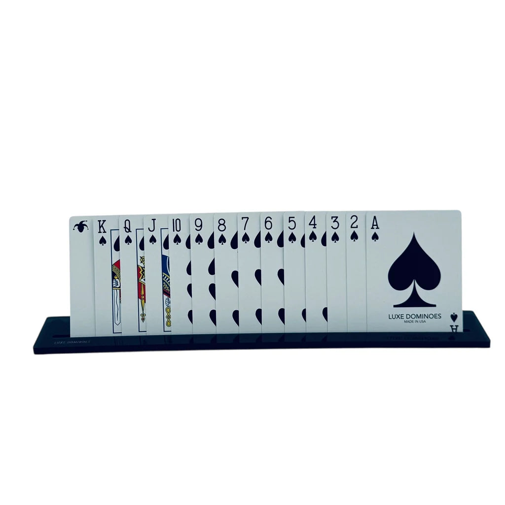 A complete suit of spades from Ace to King, plus a joker, is elegantly displayed upright on a Luxe Dominoes Luxe Canasta & More Card Rack. The crisp white cards with bold black spade symbols are neatly organized in this sleek, premium card rack from the set of four.
