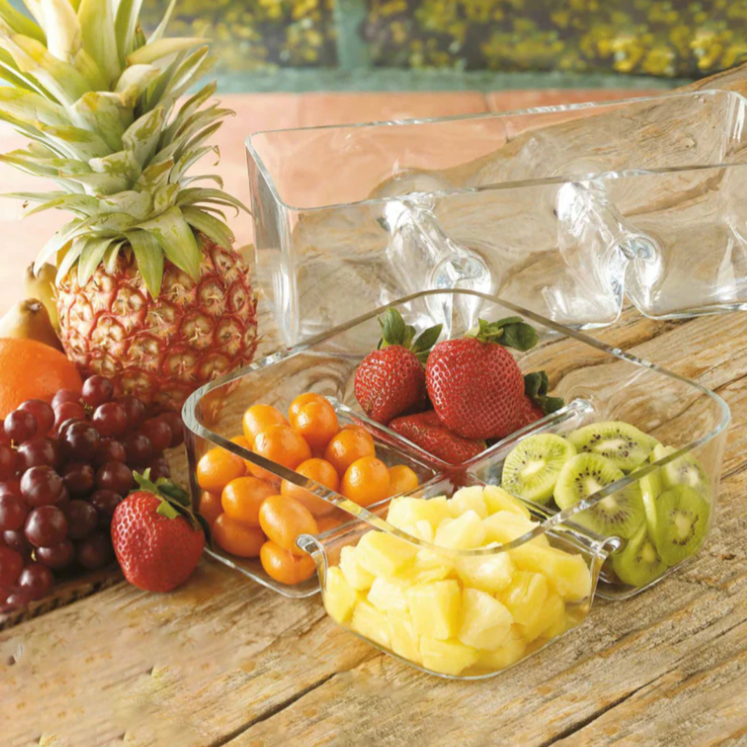 The Majestic Gifts/Barski 4 Section Square Relish Dish, dishwasher safe for easy cleanup, holds strawberries, grape tomatoes, kiwi slices, and pineapple chunks on a rustic wooden table with grapes and strawberries nearby.