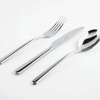 The Sambonet Linear Solid Handle Flatware 5 Place Setting—featuring sleek modern design—is artfully displayed side by side on a white surface.