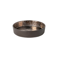 The Costa Nova Lagoa Dinnerware tray is a round, shallow stoneware piece with a dark finish, reflective textured interior, and smooth exterior, crafted in Portugal and displayed on a white background.