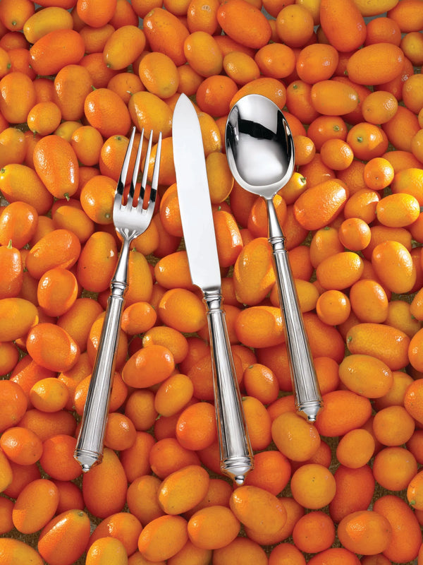 Ricci's Rialto Flatware 5-Piece Setting rests on a bed of kumquats.