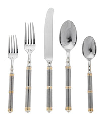 The Ricci Castello Flatware Gold 5-Piece Setting features 24kt gold-accented handles and includes a dinner fork, salad fork, knife, soup spoon, and teaspoon—all arranged in a straight line on a white background.